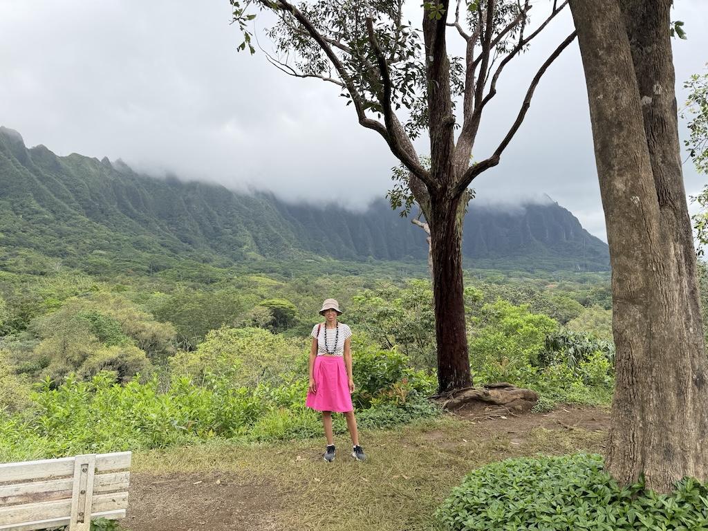 Luna standing in front of mountains at Ho’omaluhia Botanical Garden, Oahu, Hawaii