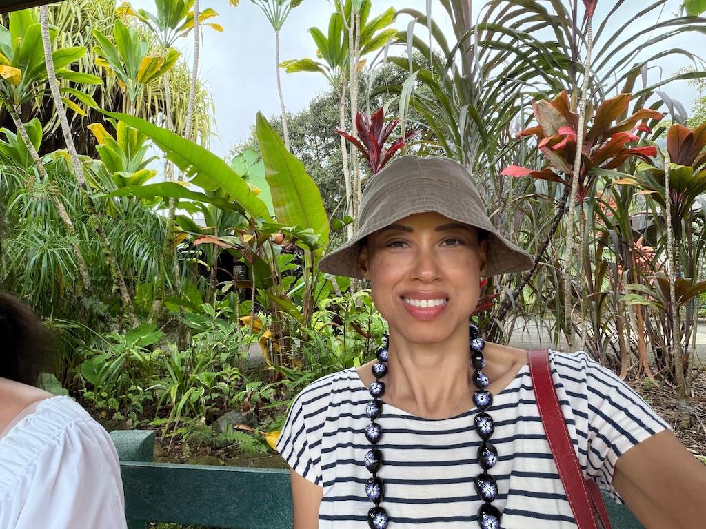 Luna smiling to camera in front of plants at Ho’omaluhia Botanical Garden, Oahu, Hawaii
