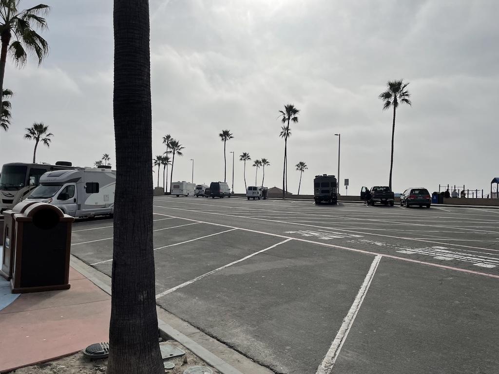 Vehicles parked in overnight lot at Oceanside Harbor, California, where Luna went van camping