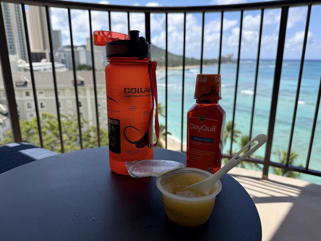 View of water bottle, medicine, and applesauce Luna had when sick in Hawaii, Waikiki Beach view