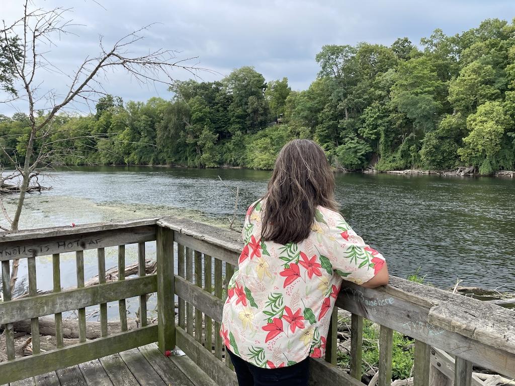 Woman standing on dock looking at St. Joseph River along the Riverfront Trail, Niles, Michigan