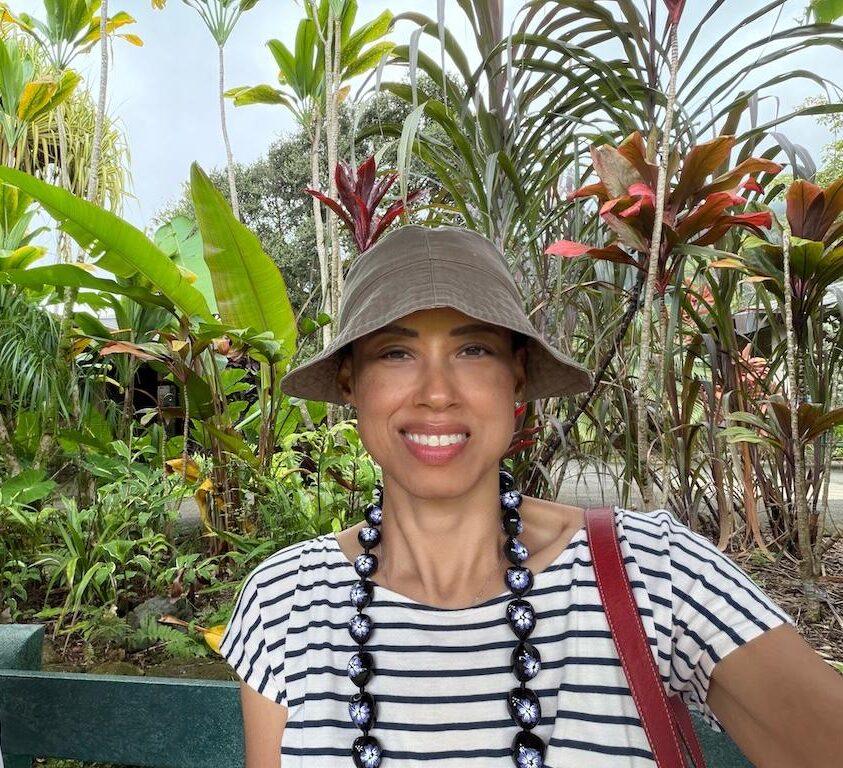 Luna smiling to camera in front of plants at Ho’omaluhia Botanical Garden, Oahu, Hawaii