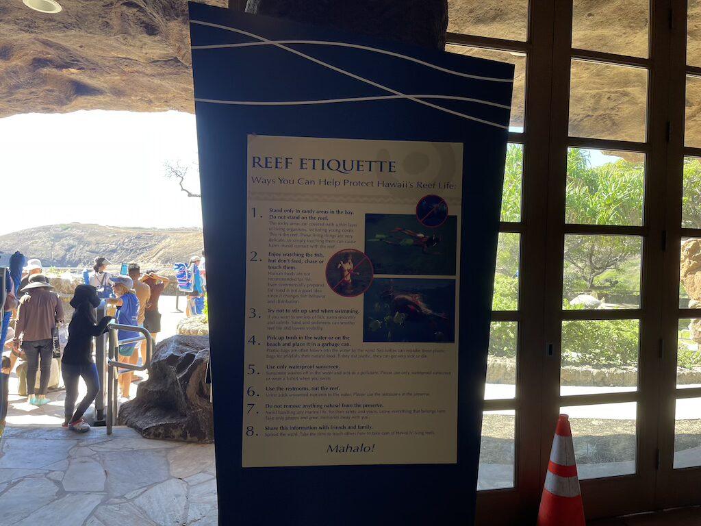 People in line behind Reef Ettiquette sign, Hanauma Bay Oahu, Hawaii